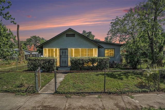 3008 E Wilder Ave, Tampa, FL 33610 - bungalow-style home with a fenced front yard, stucco siding, and a gate
