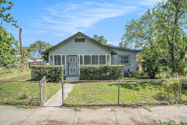 3008 E Wilder Ave, Tampa, FL 33610 - bungalow-style home featuring stucco siding, a fenced front yard, and a gate