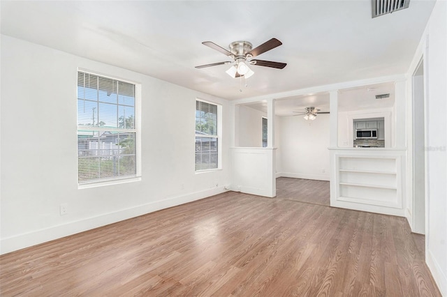 3008 E Wilder Ave, Tampa, FL 33610 - unfurnished living room with a ceiling fan and wood finished floors