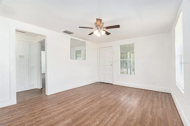3008 E Wilder Ave, Tampa, FL 33610 - unfurnished room featuring wood finished floors, plenty of natural light, and a ceiling fan