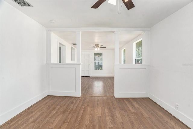 3008 E Wilder Ave, Tampa, FL 33610 - unfurnished room with a ceiling fan, wood finished floors, a smoke detector, and decorative columns