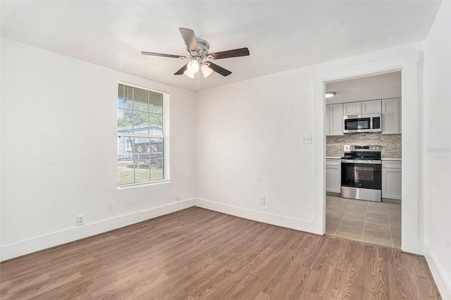 3008 E Wilder Ave, Tampa, FL 33610 - unfurnished room featuring light wood-style floors and a ceiling fan