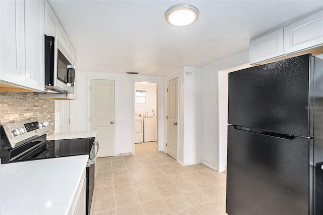 3008 E Wilder Ave, Tampa, FL 33610 - kitchen featuring appliances with stainless steel finishes, washer and dryer, decorative backsplash, light countertops, and white cabinetry