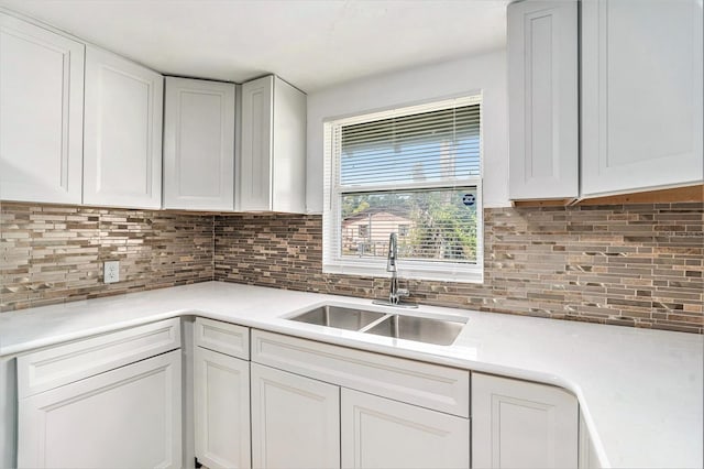 3008 E Wilder Ave, Tampa, FL 33610 - kitchen featuring light countertops, backsplash, and white cabinetry