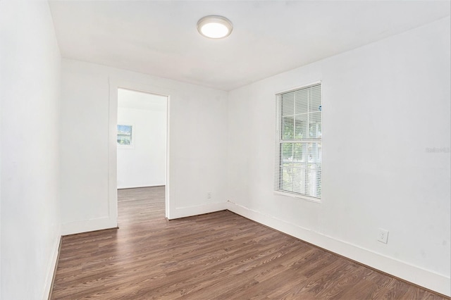3008 E Wilder Ave, Tampa, FL 33610 - spare room featuring dark wood-style flooring and plenty of natural light