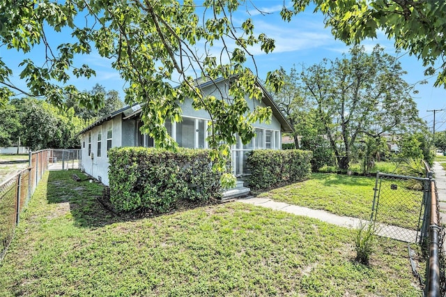 3008 E Wilder Ave, Tampa, FL 33610 - view of side of property featuring stucco siding, a fenced backyard, and a gate