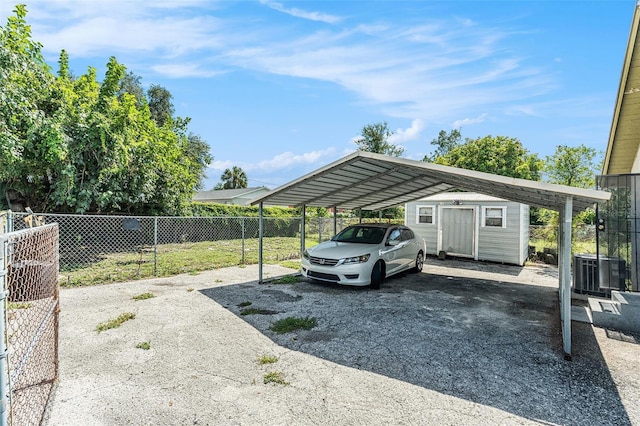 3008 E Wilder Ave, Tampa, FL 33610 - view of car parking with a detached carport, driveway, and a storage unit