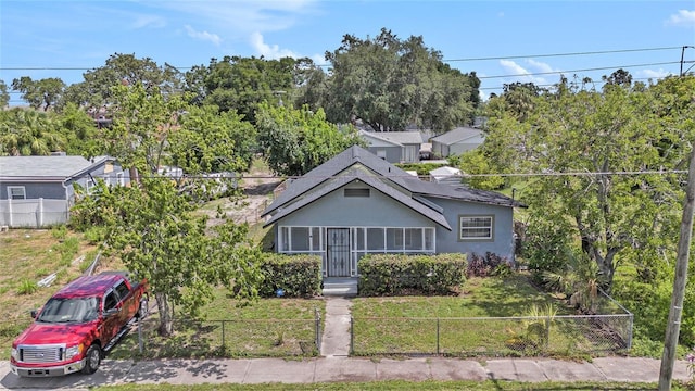 3008 E Wilder Ave, Tampa, FL 33610 - bungalow-style house with a fenced front yard, stucco siding, and view of scattered trees