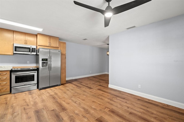 2809 Marconi St, Tampa, FL 33605 - kitchen featuring stainless steel appliances, light wood-style flooring, baseboards, light countertops, and ceiling fan
