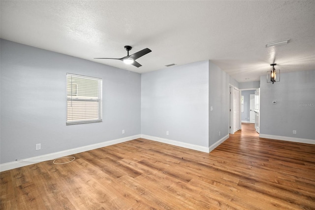 2809 Marconi St, Tampa, FL 33605 - unfurnished room with light wood finished floors, ceiling fan, baseboards, and a textured ceiling