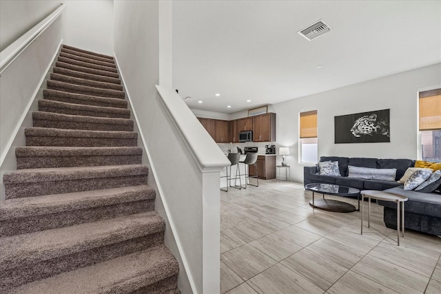 4206 W N B St Unit 1, Tampa, FL 33609 - staircase featuring plenty of natural light, recessed lighting, and tile patterned floors