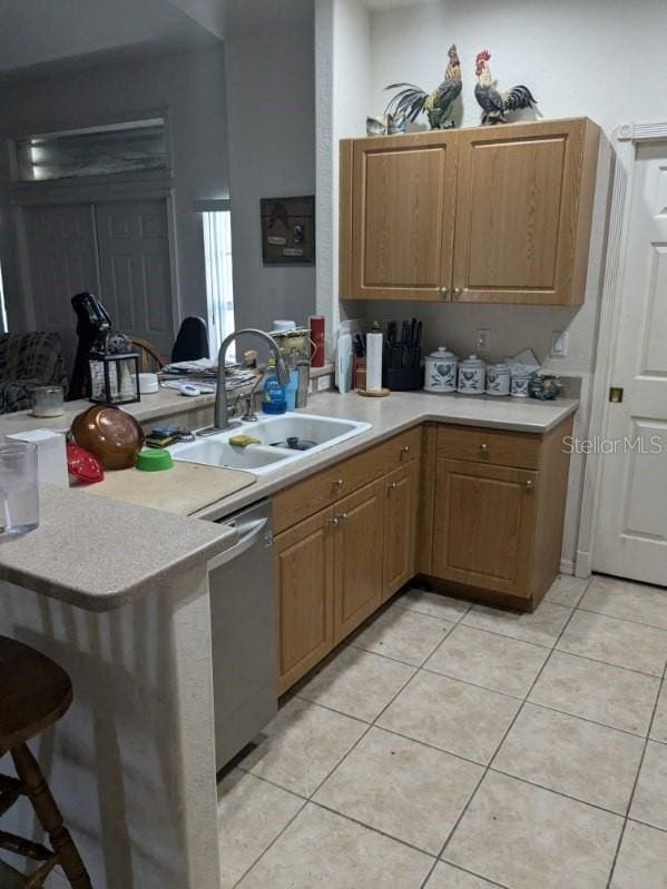 9761 Councilor Ln, North Fort Myers, FL 33917 - kitchen with a sink, stainless steel dishwasher, a peninsula, and light countertops
