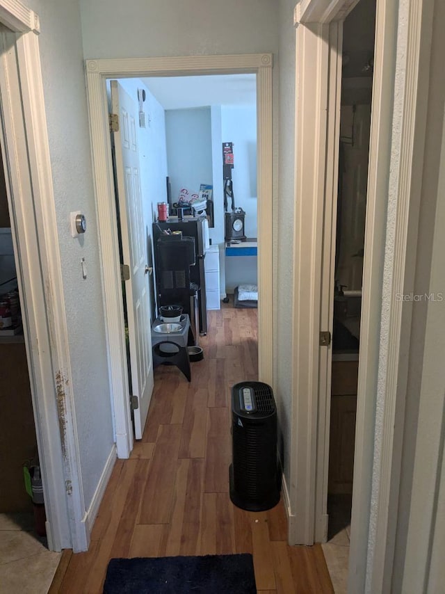 9761 Councilor Ln, North Fort Myers, FL 33917 - corridor with light wood-type flooring, a desk, and baseboards
