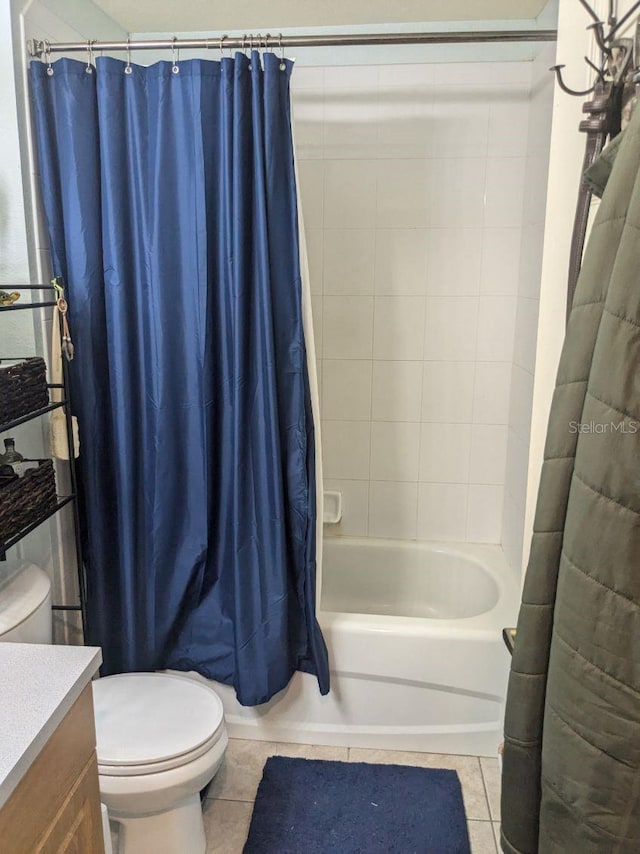9761 Councilor Ln, North Fort Myers, FL 33917 - bathroom with toilet, tile patterned floors, vanity, and shower / bathtub combination with curtain