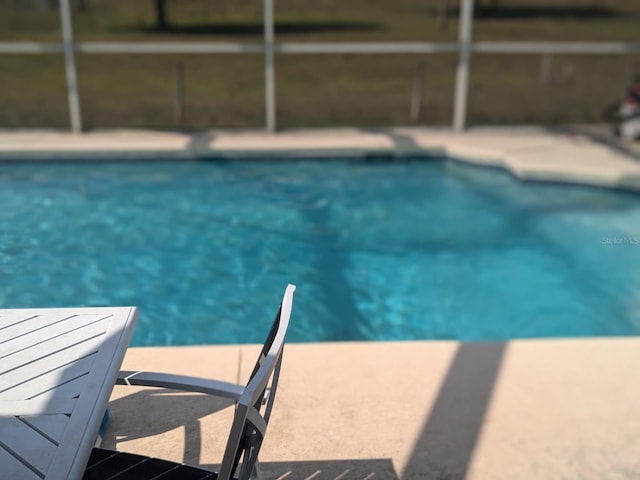9761 Councilor Ln, North Fort Myers, FL 33917 - outdoor pool featuring glass enclosure