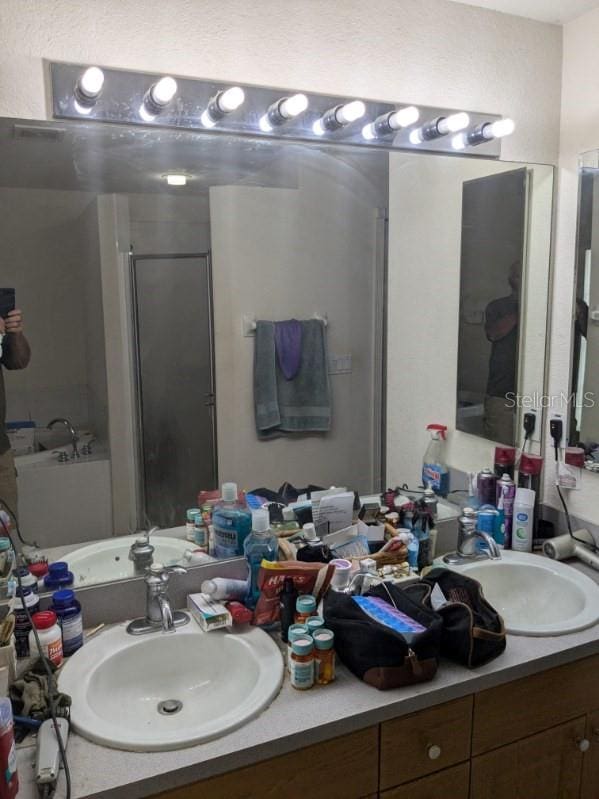 9761 Councilor Ln, North Fort Myers, FL 33917 - full bathroom with double vanity and an enclosed shower