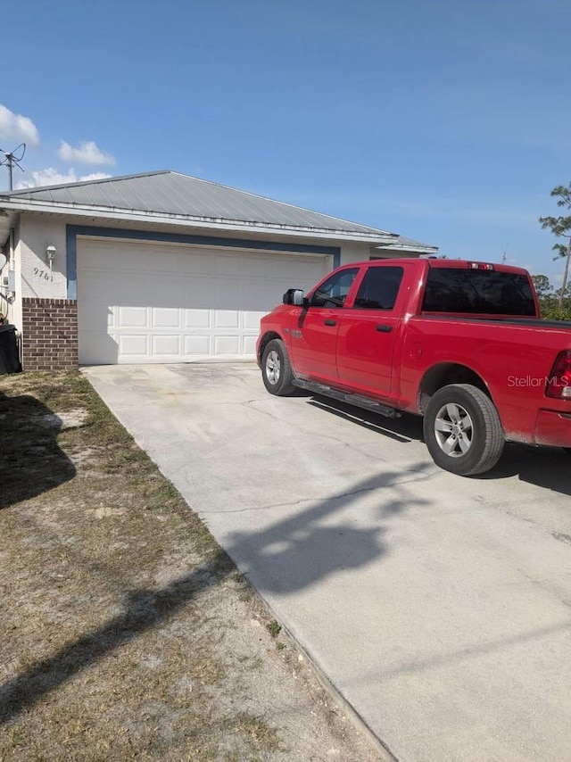 9761 Councilor Ln, North Fort Myers, FL 33917 - view of side of property with a garage and brick siding