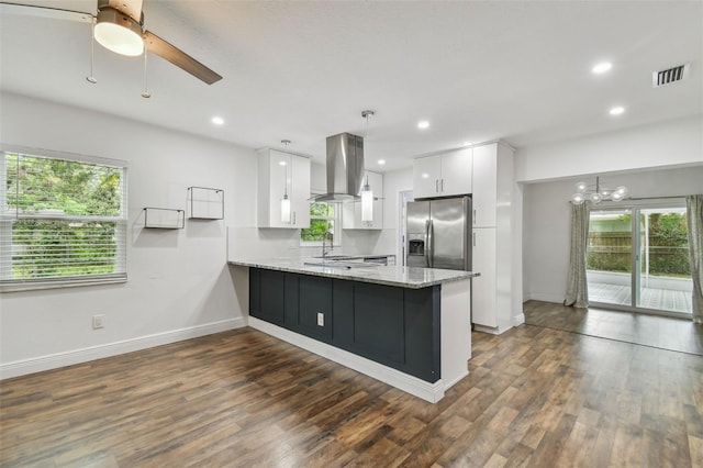 1311 W Perdiz St, Tampa, FL 33612 - kitchen featuring island range hood, stainless steel fridge with ice dispenser, a peninsula, white cabinets, and dark wood-style floors