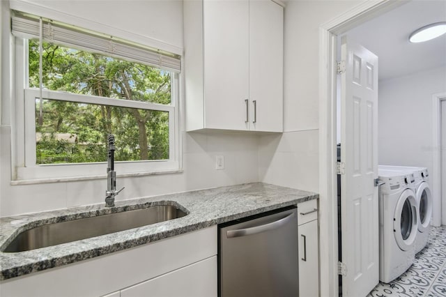 1311 W Perdiz St, Tampa, FL 33612 - kitchen featuring stainless steel dishwasher, washer and dryer, white cabinets, and light stone counters