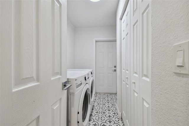 1311 W Perdiz St, Tampa, FL 33612 - laundry room with separate washer and dryer, a textured wall, and light tile patterned floors