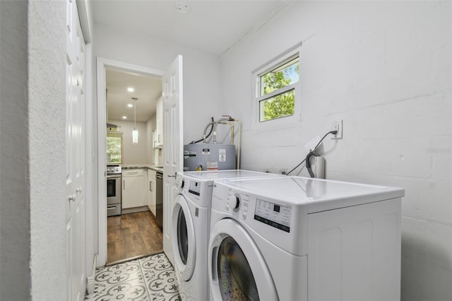 1311 W Perdiz St, Tampa, FL 33612 - laundry area featuring separate washer and dryer, water heater, light tile patterned flooring, and recessed lighting