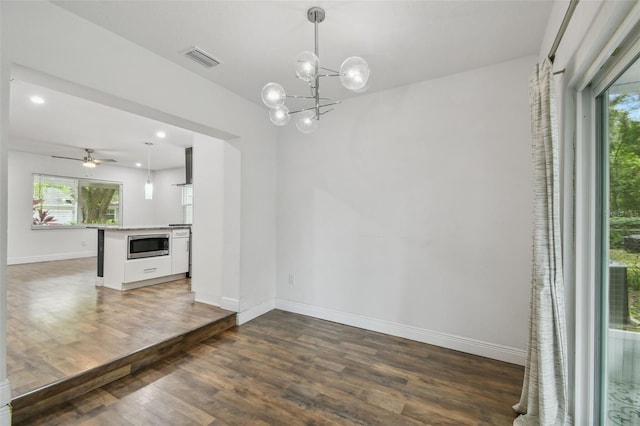 1311 W Perdiz St, Tampa, FL 33612 - unfurnished dining area featuring wood finished floors, healthy amount of natural light, a chandelier, and recessed lighting