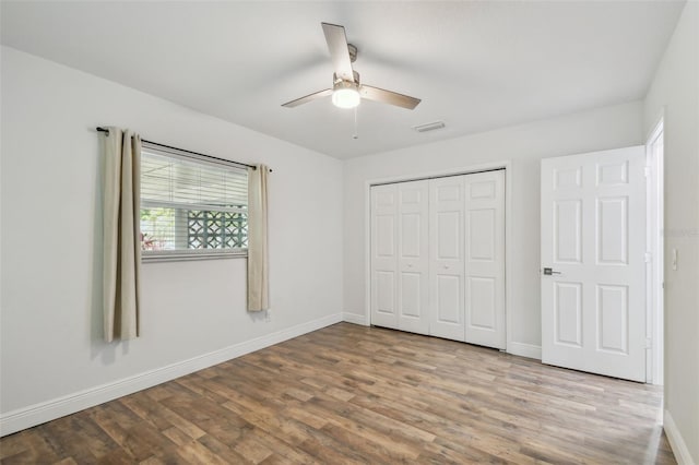 1311 W Perdiz St, Tampa, FL 33612 - unfurnished bedroom featuring wood finished floors, a closet, and ceiling fan