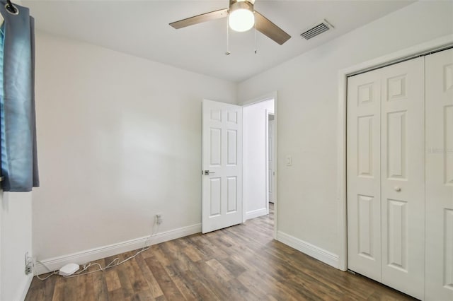 1311 W Perdiz St, Tampa, FL 33612 - unfurnished bedroom featuring dark wood-style floors, a closet, and a ceiling fan