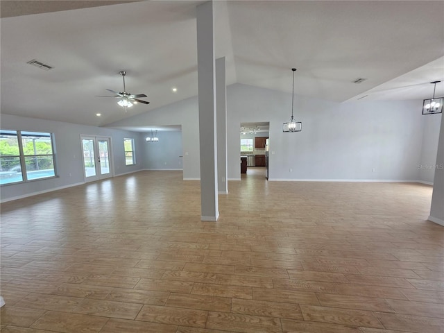 13551 Banner Rd, Spring Hill, FL 34609 - unfurnished living room featuring a chandelier, lofted ceiling, wood finished floors, and baseboards