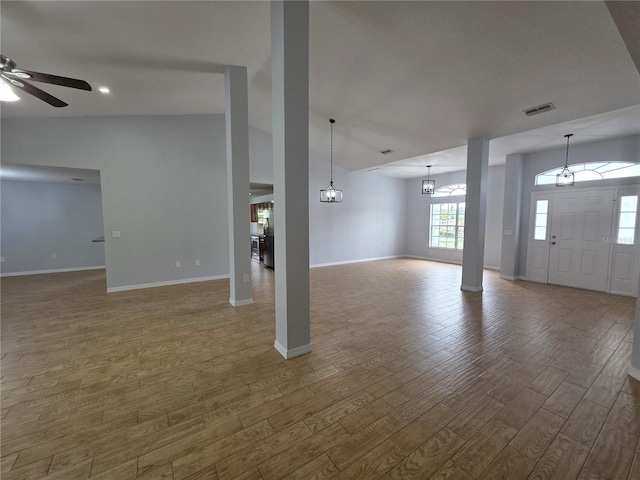 13551 Banner Rd, Spring Hill, FL 34609 - unfurnished living room with wood finished floors, baseboards, a chandelier, and ceiling fan