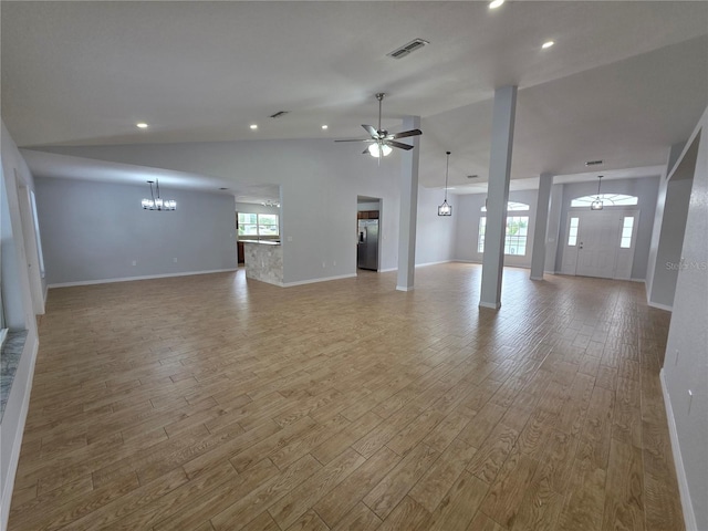 13551 Banner Rd, Spring Hill, FL 34609 - unfurnished living room with a chandelier, wood finished floors, vaulted ceiling, baseboards, and a ceiling fan