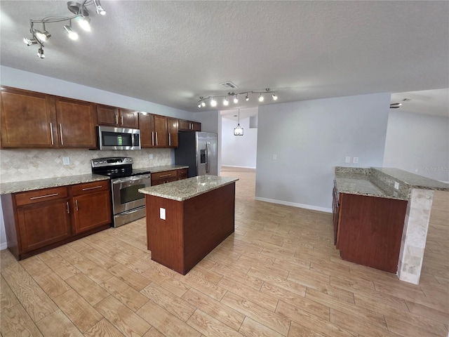 13551 Banner Rd, Spring Hill, FL 34609 - kitchen with stainless steel appliances, backsplash, track lighting, baseboards, and light wood-style floors
