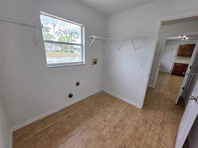 13551 Banner Rd, Spring Hill, FL 34609 - laundry area with hookup for an electric dryer, washer hookup, light wood finished floors, and baseboards