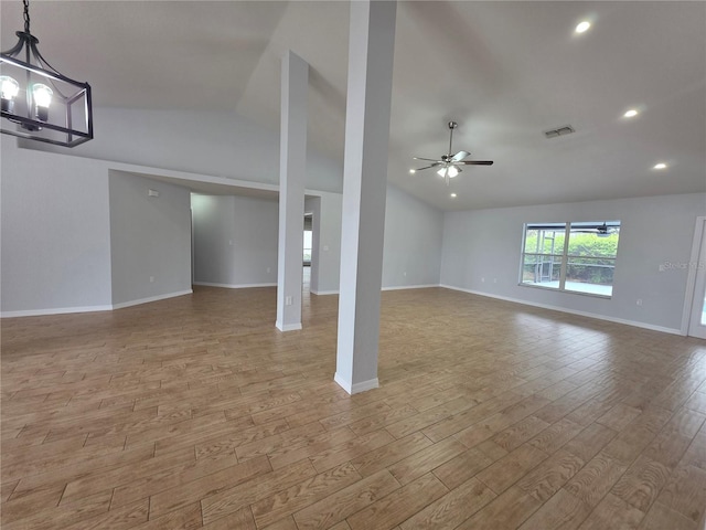 13551 Banner Rd, Spring Hill, FL 34609 - unfurnished living room with vaulted ceiling, a ceiling fan, wood finished floors, a chandelier, and baseboards