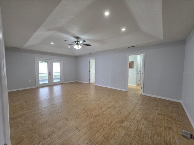 13551 Banner Rd, Spring Hill, FL 34609 - spare room featuring a raised ceiling, light wood finished floors, baseboards, and recessed lighting