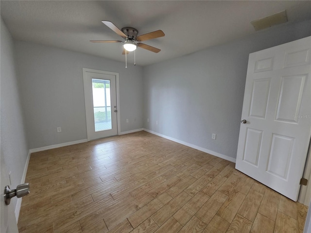 13551 Banner Rd, Spring Hill, FL 34609 - spare room with a ceiling fan, light wood-type flooring, and baseboards