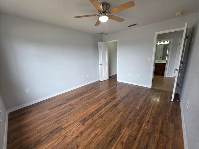 13551 Banner Rd, Spring Hill, FL 34609 - unfurnished bedroom with dark wood finished floors, baseboards, and a ceiling fan