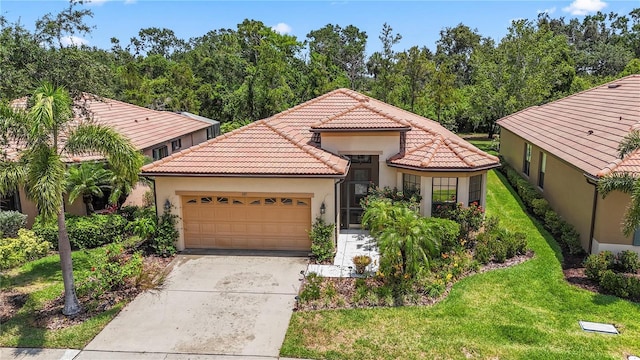 137 Silver Falls Dr, Apollo Beach, FL 33572 - mediterranean / spanish-style house featuring stucco siding, a tiled roof, a garage, driveway, and a front lawn