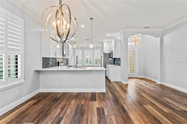 137 Silver Falls Dr, Apollo Beach, FL 33572 - kitchen featuring a chandelier, light countertops, crown molding, a sink, and healthy amount of natural light