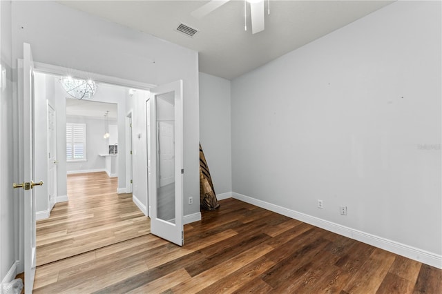 137 Silver Falls Dr, Apollo Beach, FL 33572 - empty room with wood finished floors, a chandelier, baseboards, and a ceiling fan