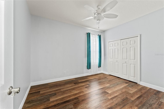 137 Silver Falls Dr, Apollo Beach, FL 33572 - unfurnished bedroom with dark wood-style flooring, baseboards, a closet, and ceiling fan