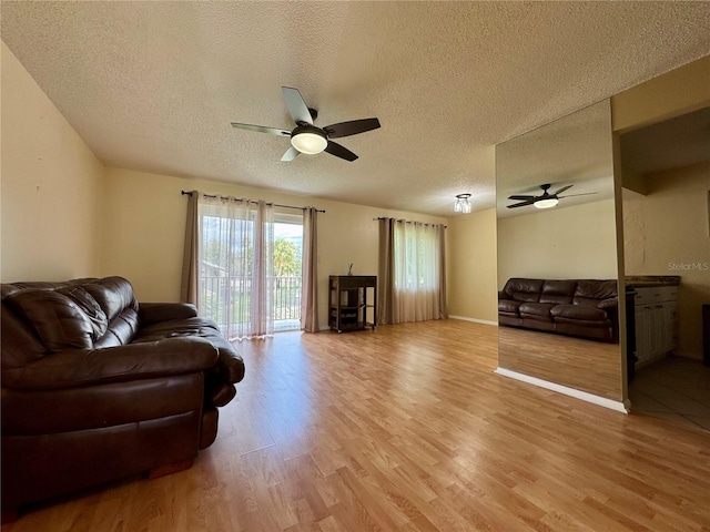 4215 E Bay Dr Unit 1707C, Clearwater, FL 33764 - living room featuring a ceiling fan, light wood-type flooring, and a textured ceiling