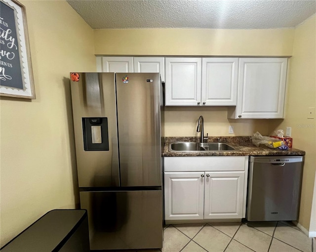 4215 E Bay Dr Unit 1707C, Clearwater, FL 33764 - kitchen with stainless steel appliances, a sink, white cabinetry, dark countertops, and a textured ceiling