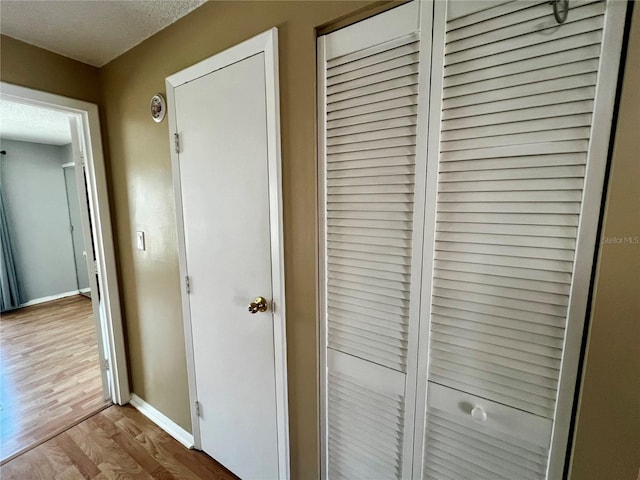 4215 E Bay Dr Unit 1707C, Clearwater, FL 33764 - detailed view of wood finished floors, baseboards, and a textured ceiling