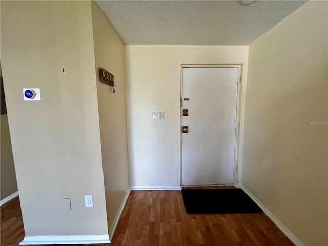4215 E Bay Dr Unit 1707C, Clearwater, FL 33764 - doorway featuring wood finished floors, baseboards, and a textured ceiling