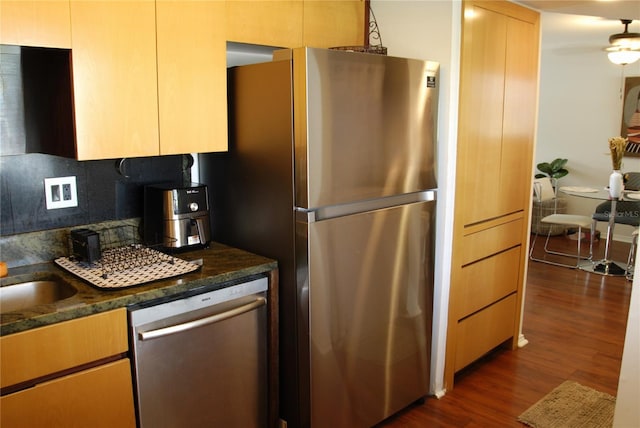 2737 Enterprise Rd E Unit 192, Clearwater, FL 33759 - kitchen with appliances with stainless steel finishes, dark wood-style flooring, backsplash, and dark stone countertops