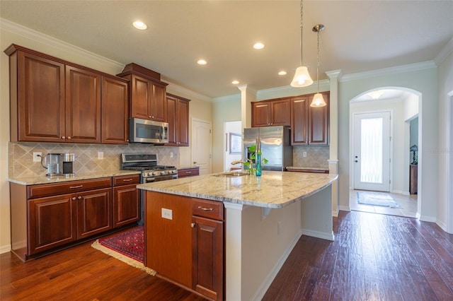11038 Spring Point Cir, Riverview, FL 33579 - kitchen featuring stainless steel appliances, arched walkways, dark wood-style floors, an island with sink, and recessed lighting