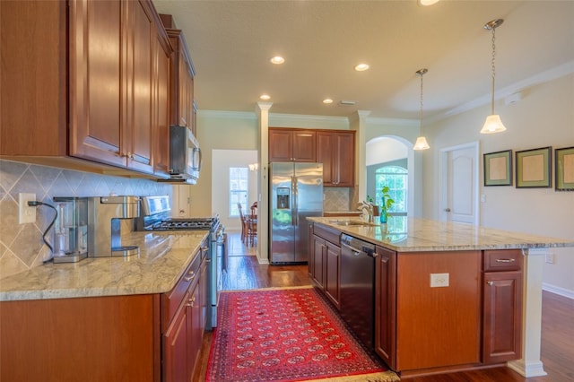 11038 Spring Point Cir, Riverview, FL 33579 - kitchen with appliances with stainless steel finishes, arched walkways, tasteful backsplash, light stone countertops, and dark wood finished floors