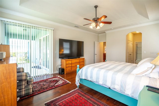 11038 Spring Point Cir, Riverview, FL 33579 - bedroom with wood finished floors, arched walkways, access to exterior, a tray ceiling, and crown molding