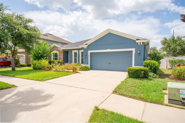 11038 Spring Point Cir, Riverview, FL 33579 - ranch-style home featuring an attached garage, a front yard, stucco siding, and concrete driveway